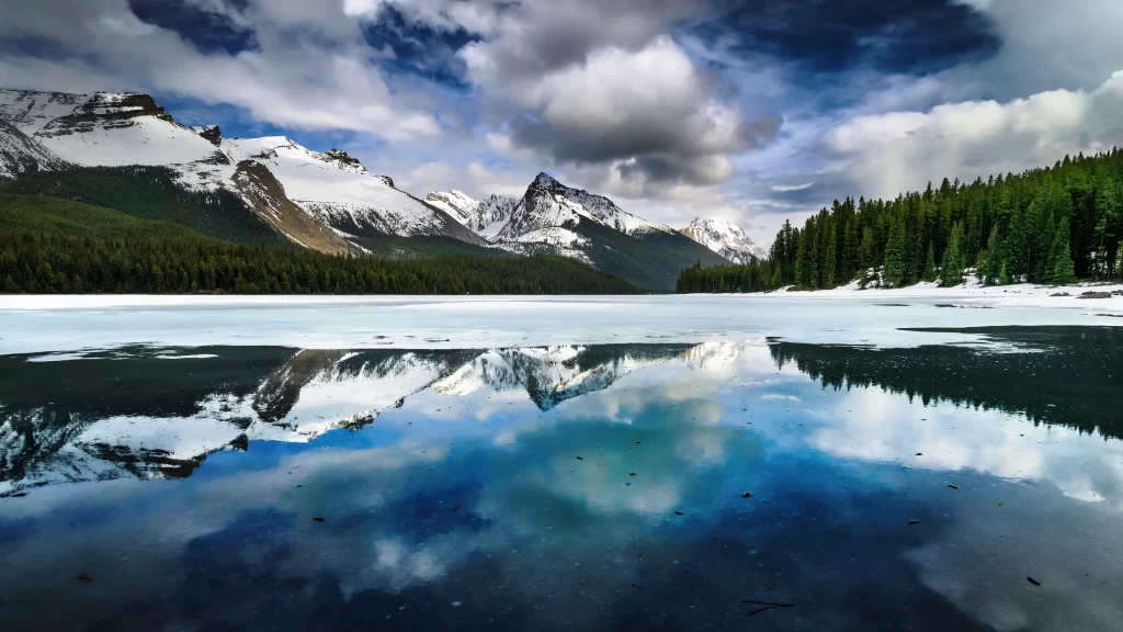 mountains snow lake reflection clouds forest