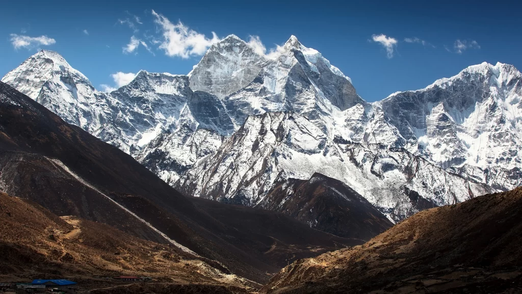 mountains snow peaks valley blue sky