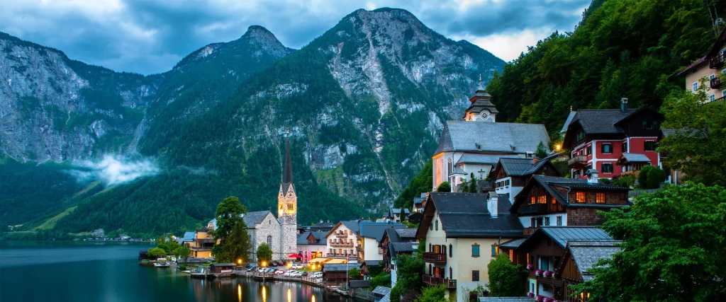 mountains village lake church buildings nature