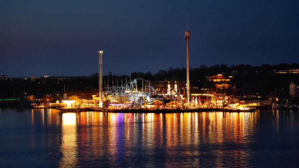 night amusement park lights reflections water