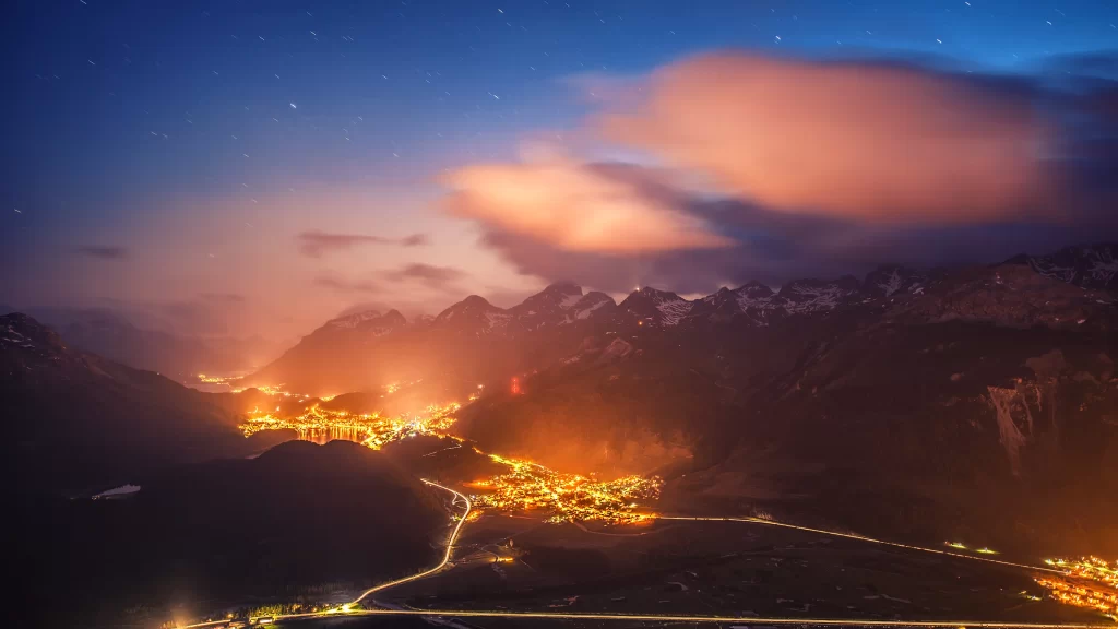 night mountain city lights clouds stars