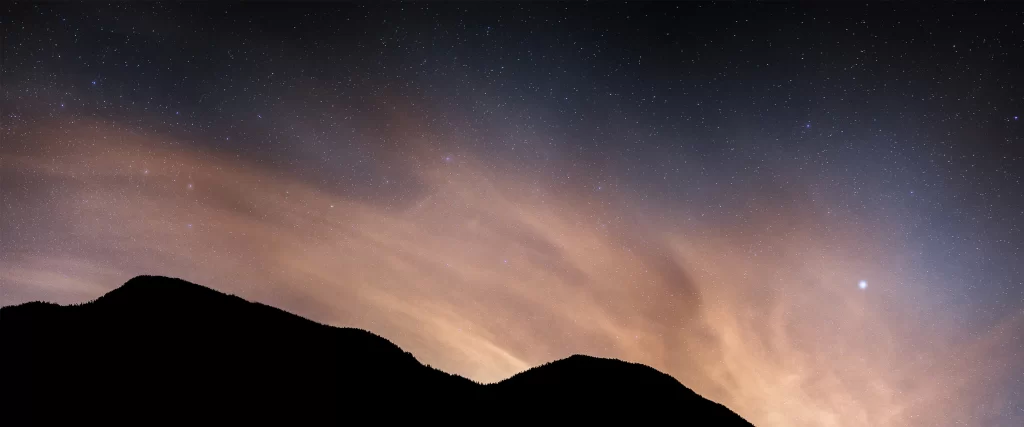 night sky stars clouds mountains silhouette