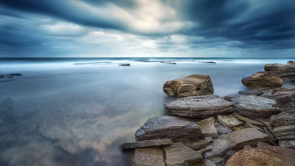 ocean rocks clouds sky water