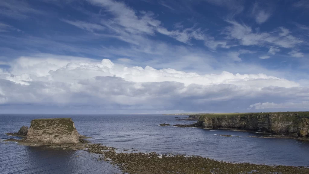 ocean sky clouds cliffs rocks water landscape nature