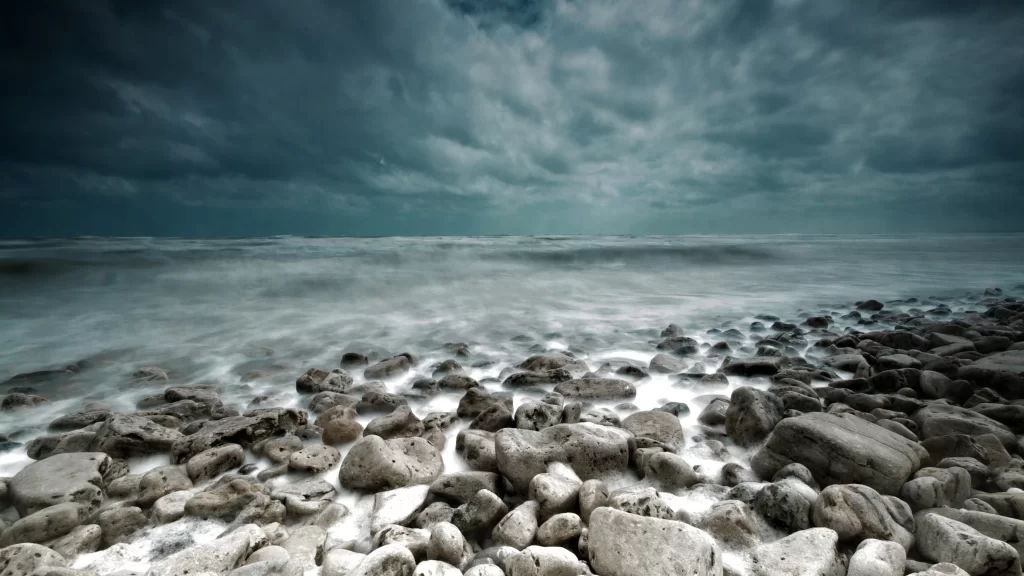 ocean storm rocks waves clouds horizon