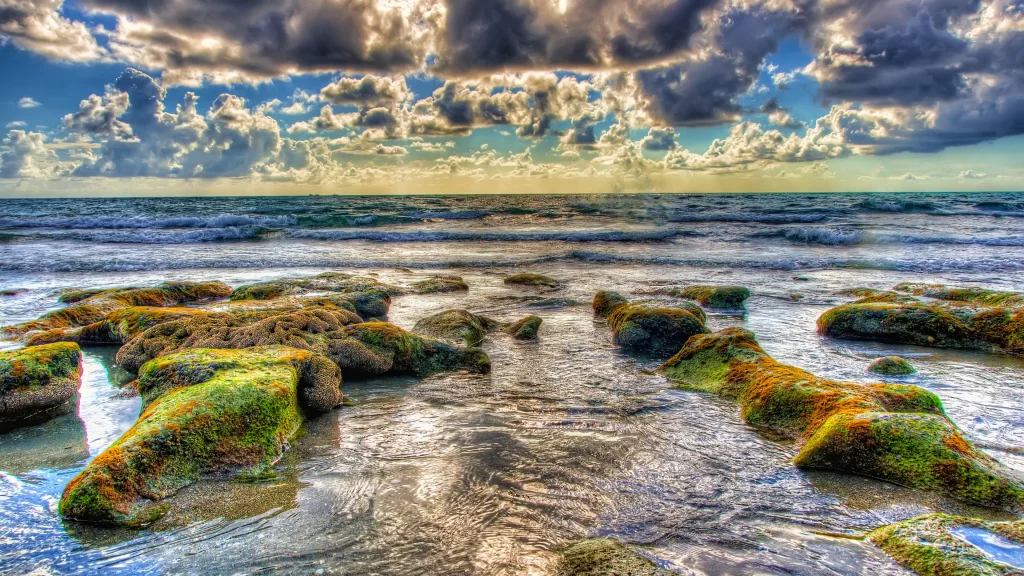 ocean waves rocks clouds sunlight beach