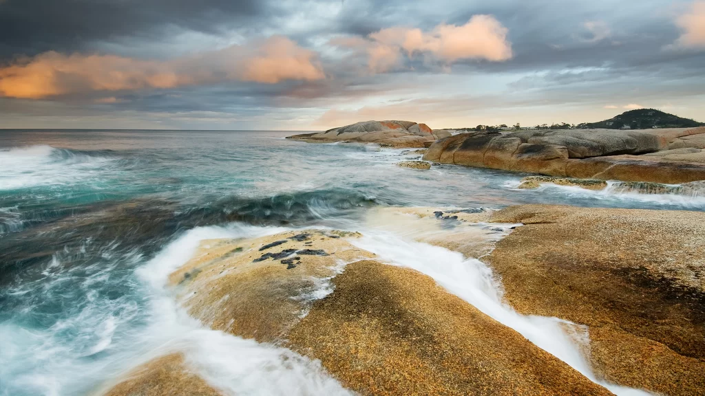 ocean waves rocky shore sunset clouds