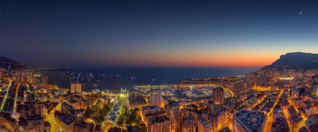 panoramic cityscape twilight ocean lights mountain