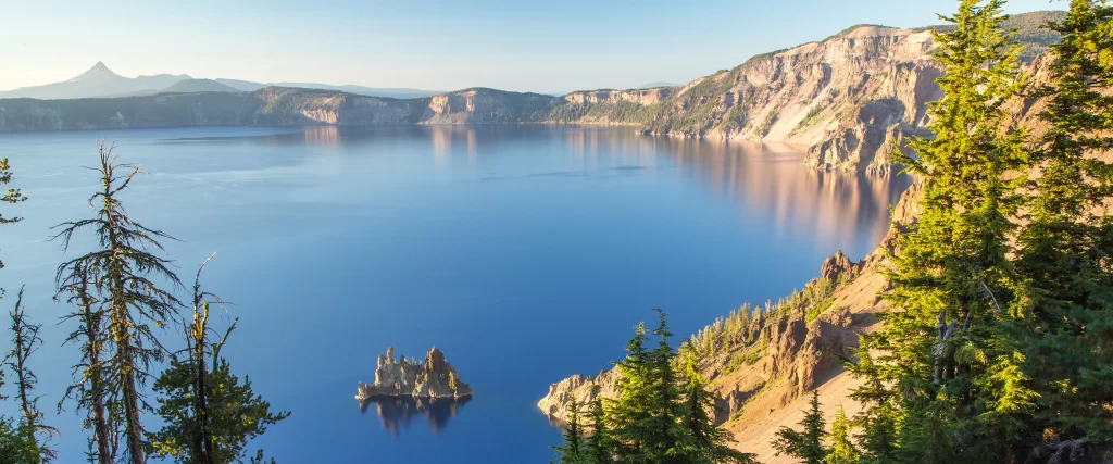 panoramic lake cliffs trees reflection mountain