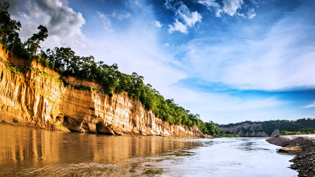 river cliffs trees sky clouds reflection