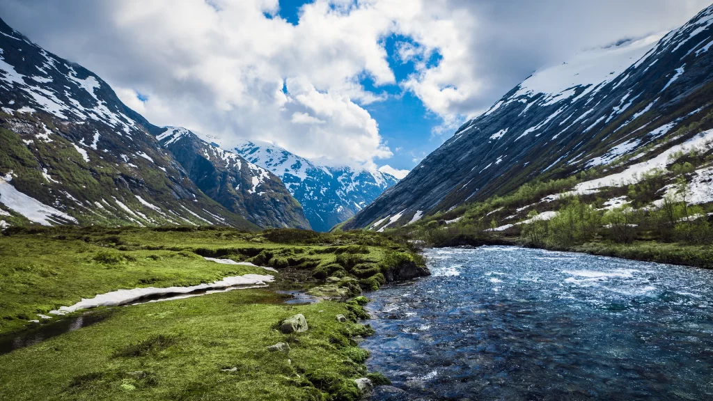 river mountains snow green sky clouds