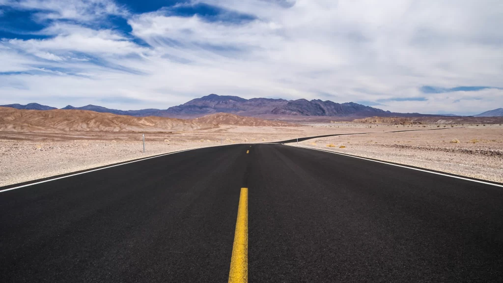 road desert mountains sky clouds landscape
