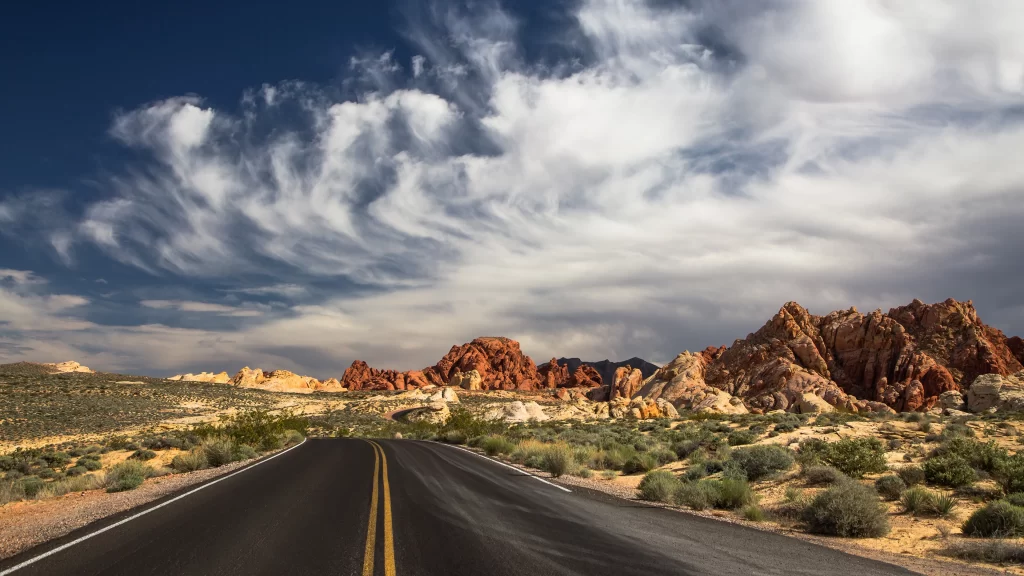 road desert mountains sky clouds landscape