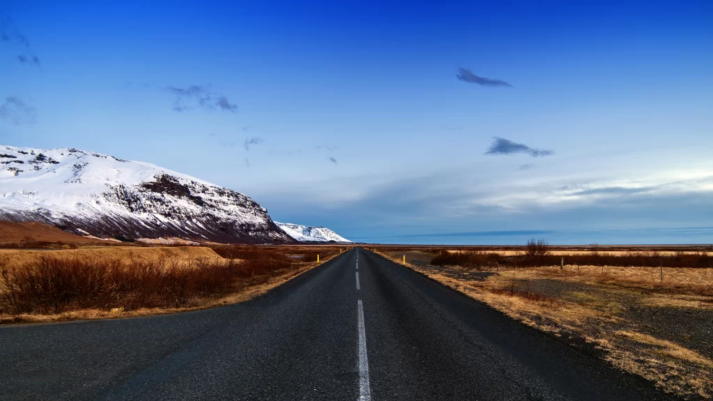 road landscape mountain snow sky clouds