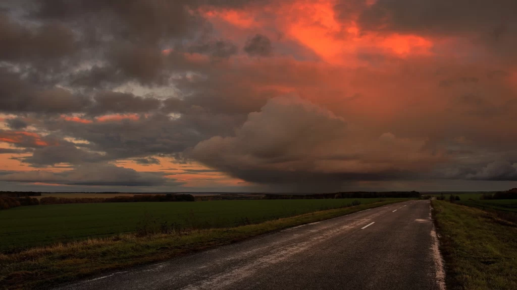 road sunset clouds landscape fields horizon