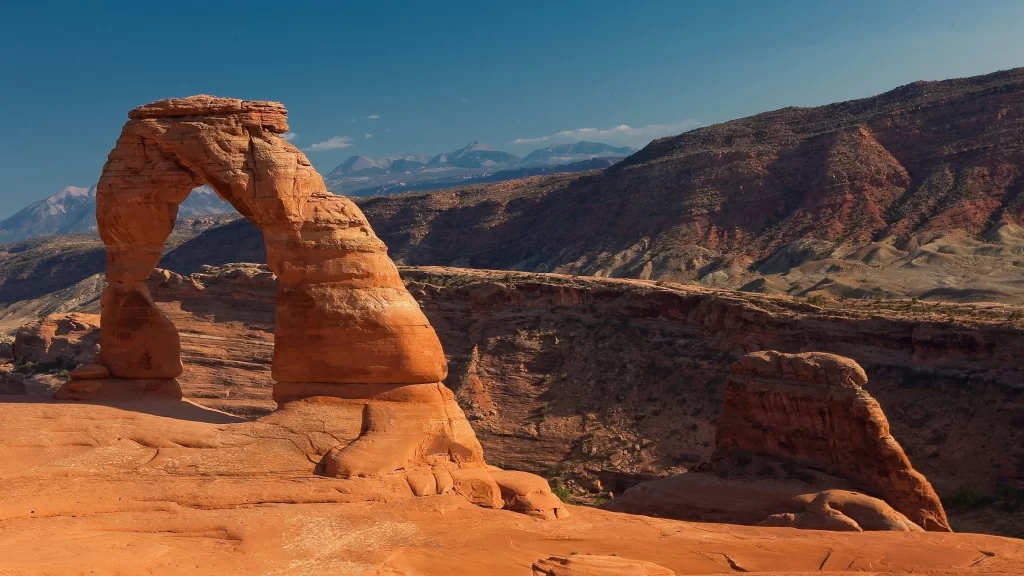 rock arch desert landscape mountain clear sky