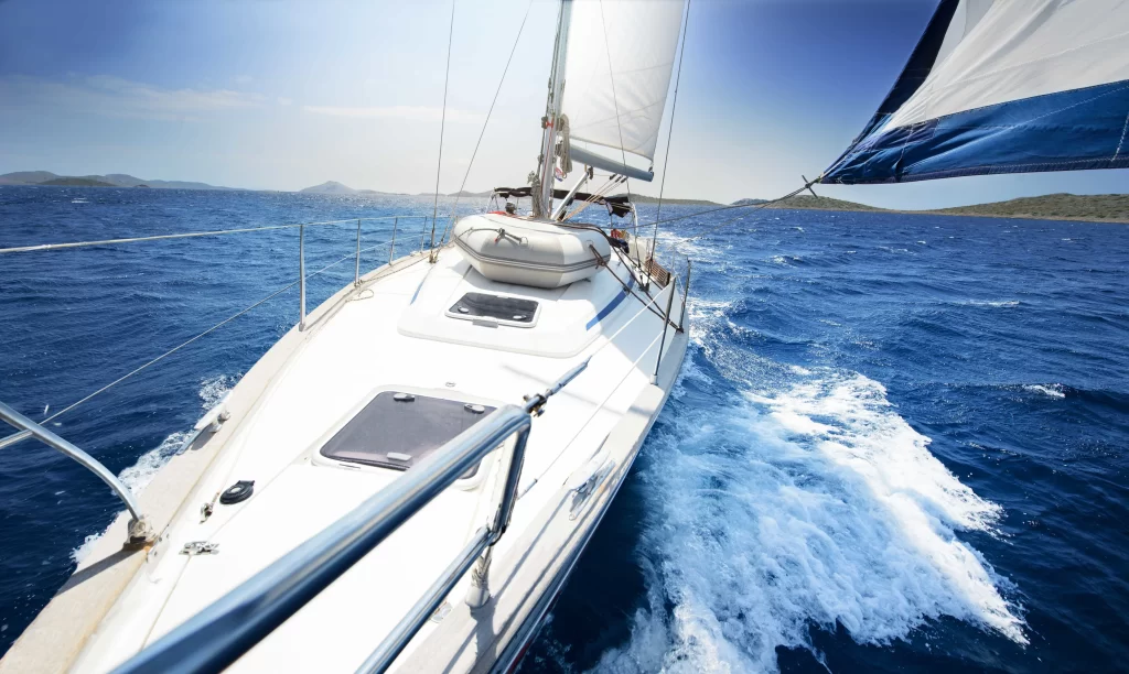 sailboat ocean waves sun sky horizon