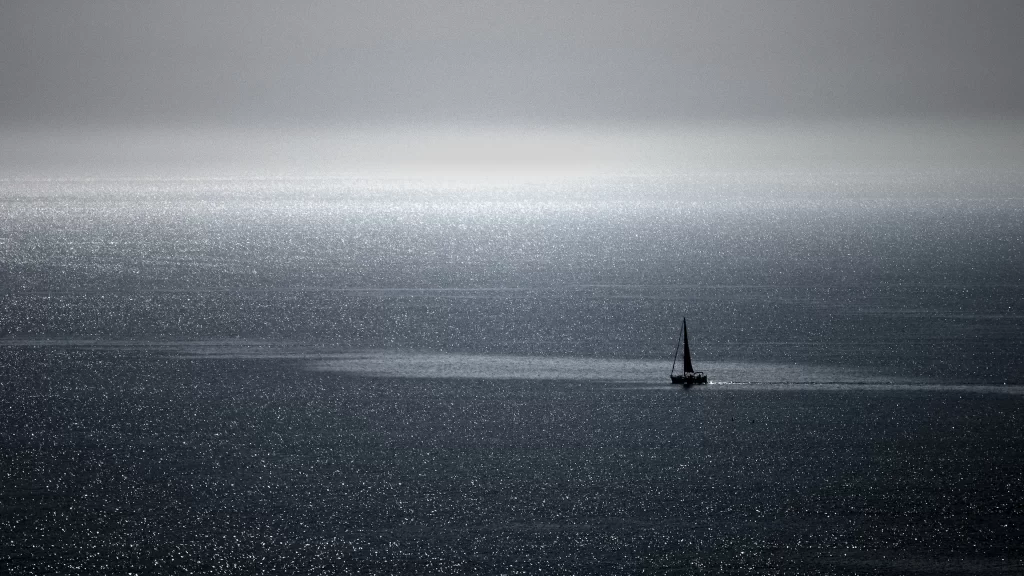 sailboat sea horizon sunlight calm solitude