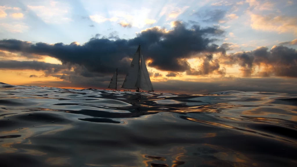 sailboat sunset ocean clouds horizon reflection