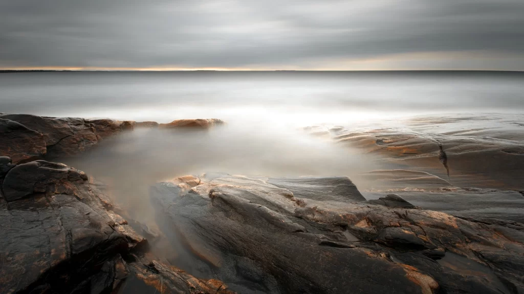 seascape rocks water sky clouds sunlight