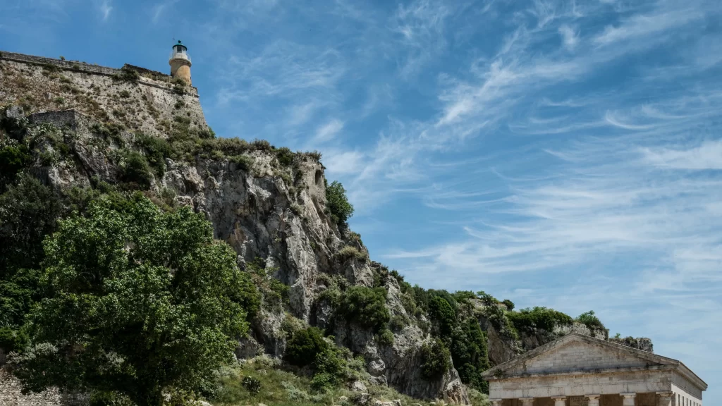 sky clouds mountain vegetation building lighthouse