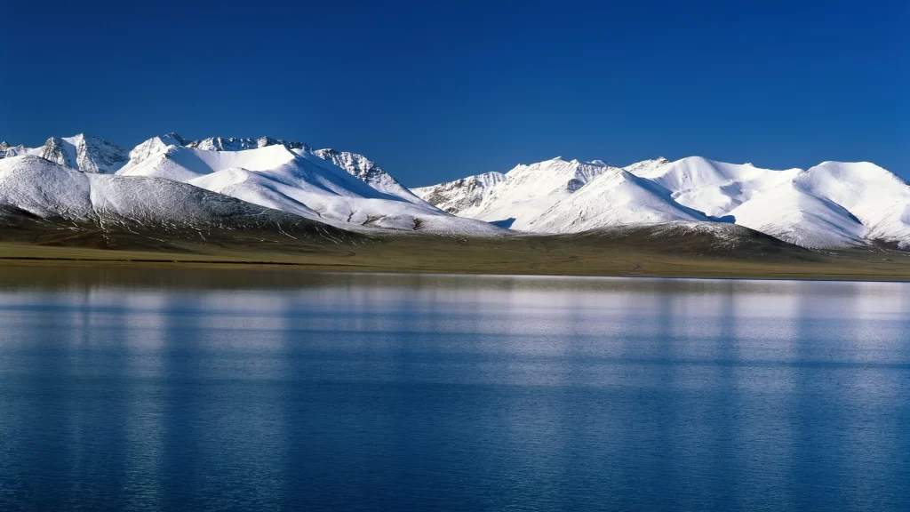 snow mountain lake clear blue sky