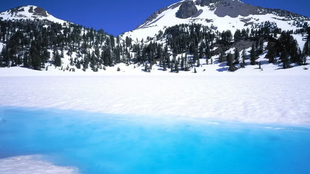 snow mountain lake trees sky