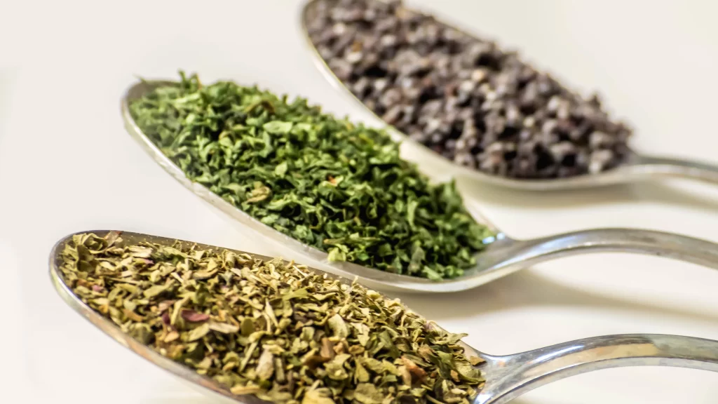 spoons herbs green black white