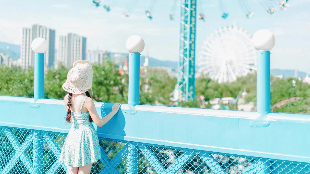 summer dress, straw hat, Ferris wheel, cityscape, blue railing, amusement park