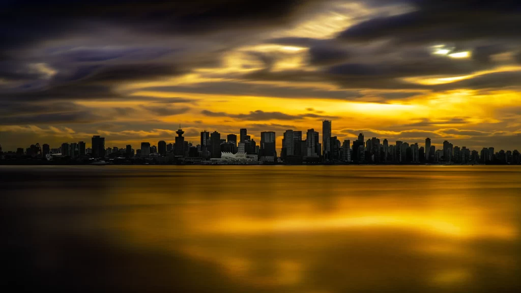 sunset cityscape skyline reflection clouds water