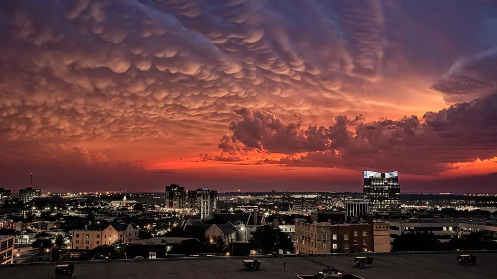 sunset clouds cityscape buildings sky orange twilight