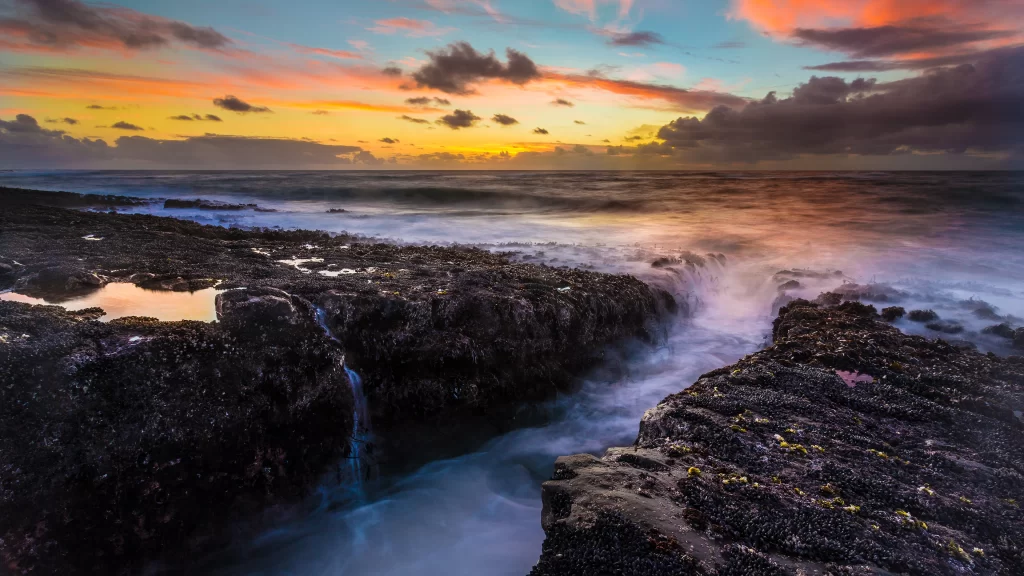 sunset ocean waves rocks sky clouds