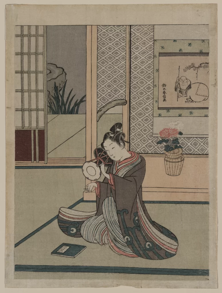 Traditional Japanese Woman Kimono Fan Indoor Setting Botanical Elements Cultural Artistry
