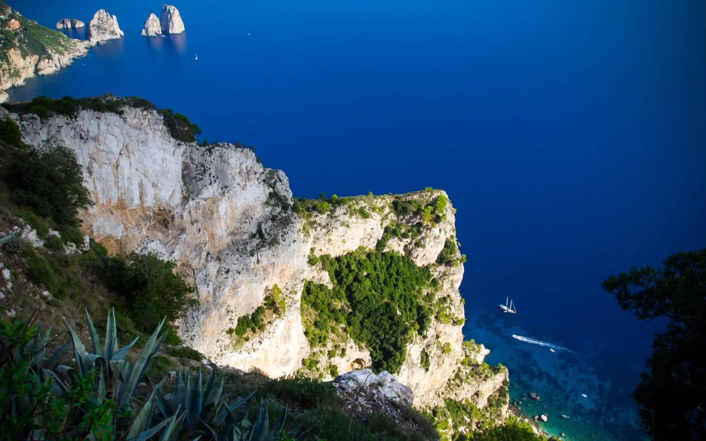 Cliffside Ocean Blue Waters Sailboat Rocky Shoreline