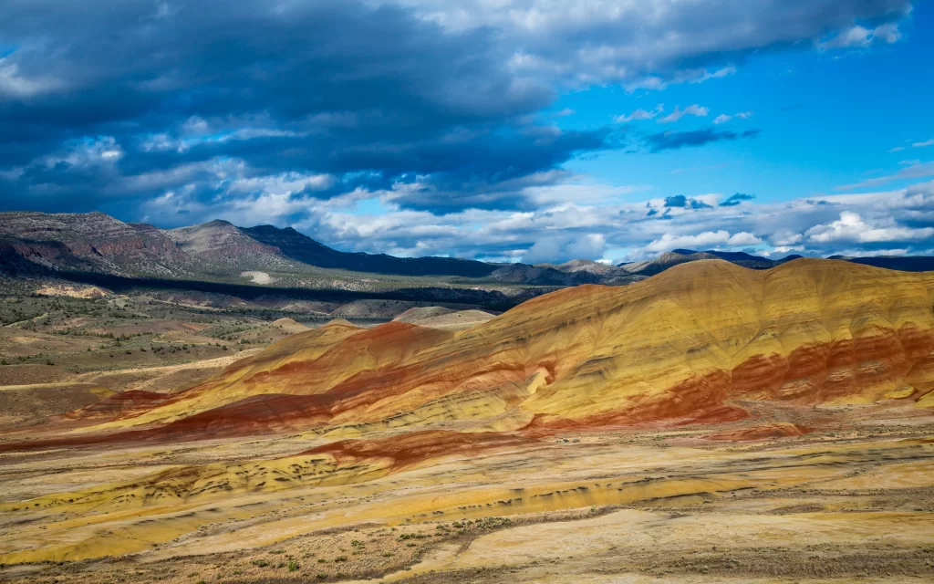 Desert Hills Rocky Terrain Colorful Layers Cloudy Sky