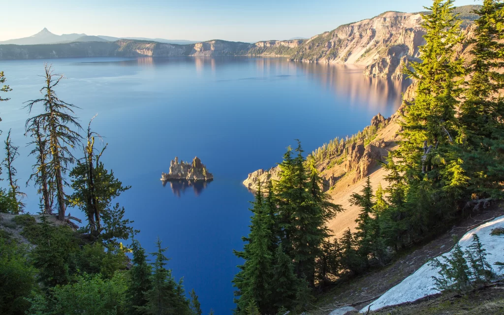 Deep Blue Lake Rocky Cliffs Evergreen Trees Clear Sky