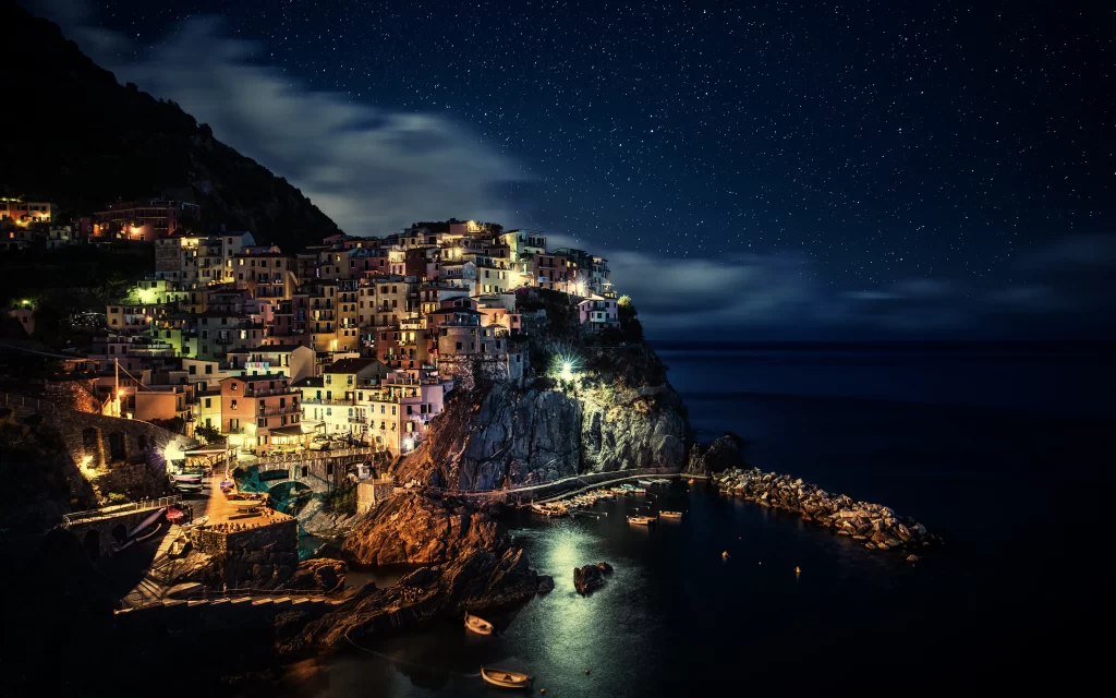 Starry Night Coastal Village Illuminated Houses Rocky Shore