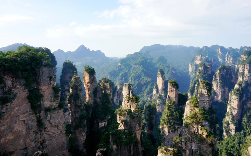 Mountain Peaks Lush Greenery Rocky Cliffs Blue Sky
