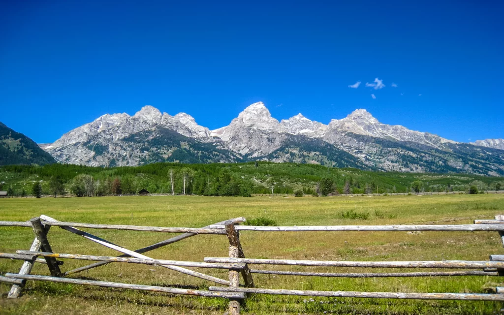 Mountain Range Clear Sky Meadow Wooden Fence Scenic Landscape