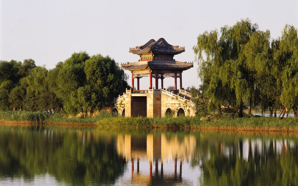 Traditional Pavilion Bridge Willow Trees Calm Water Reflection