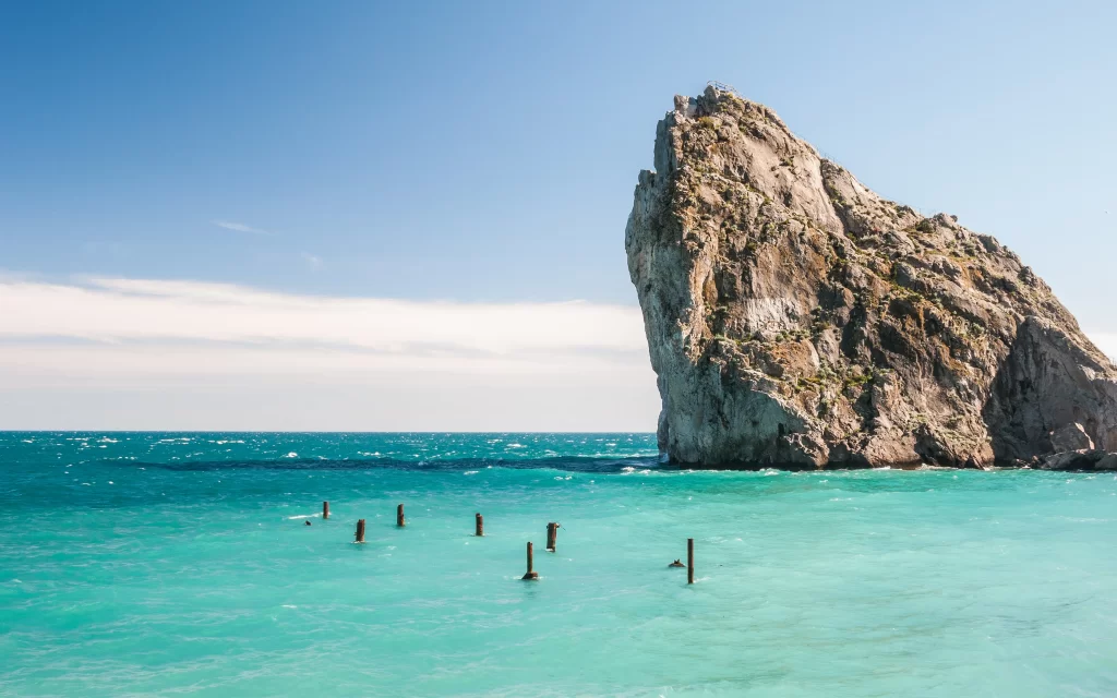 Rocky Cliff Turquoise Sea Sky Clouds