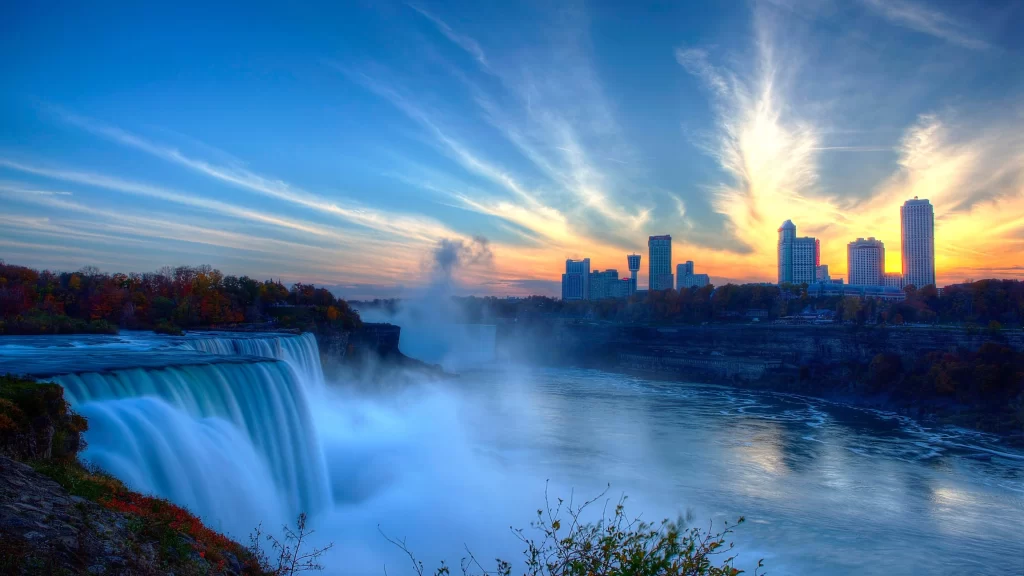 waterfall cityscape sunset sky clouds river