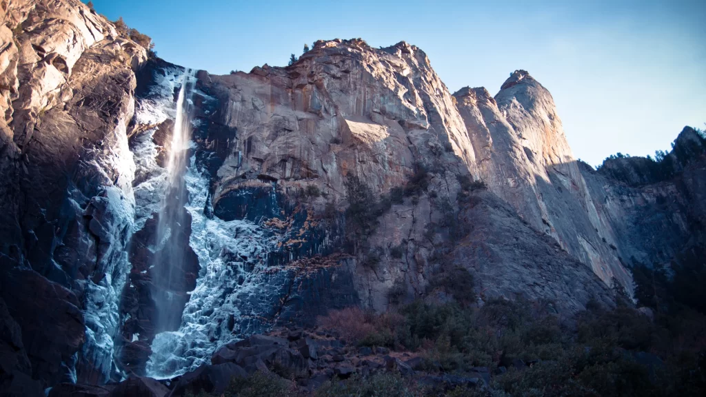 waterfall mountain rock snow clear sky