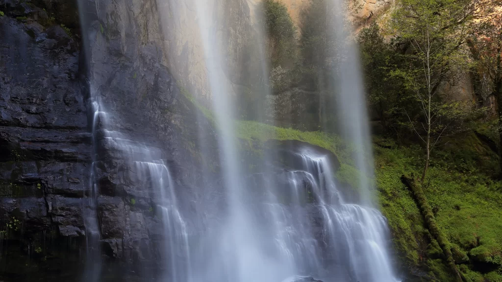 waterfall nature greenery rocks sunlight serene landscape