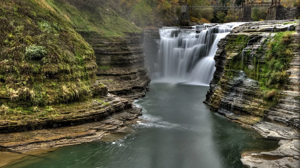 waterfall nature landscape serene rocks greenery