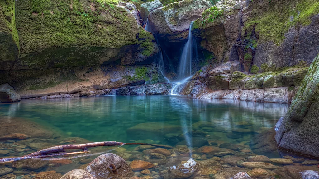 waterfall pool rocks moss nature serene