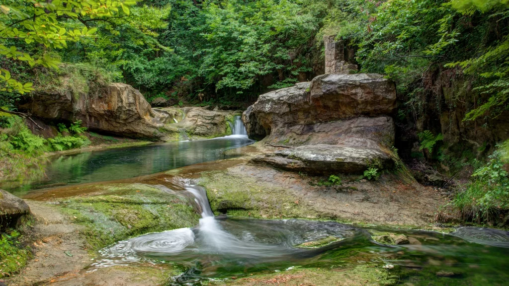waterfall stream rocks greenery nature tranquility