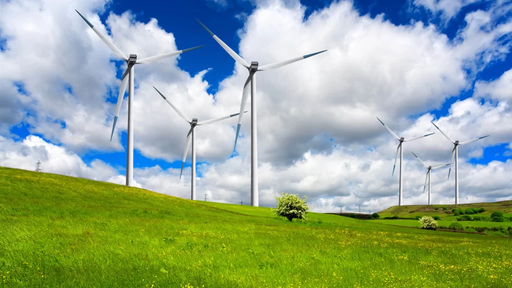 wind turbines green grass blue sky white clouds renewable energy landscape