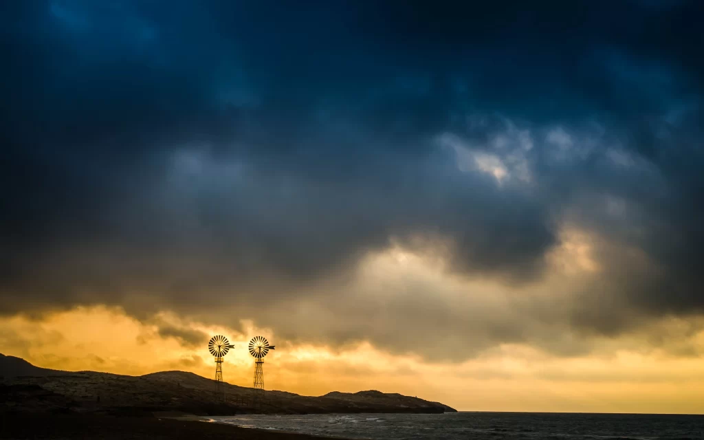wind turbines sunset clouds ocean landscape horizon