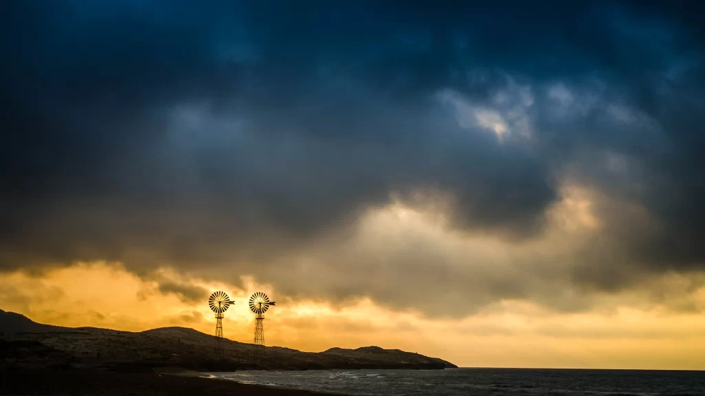 wind turbines sunset clouds ocean landscape horizon